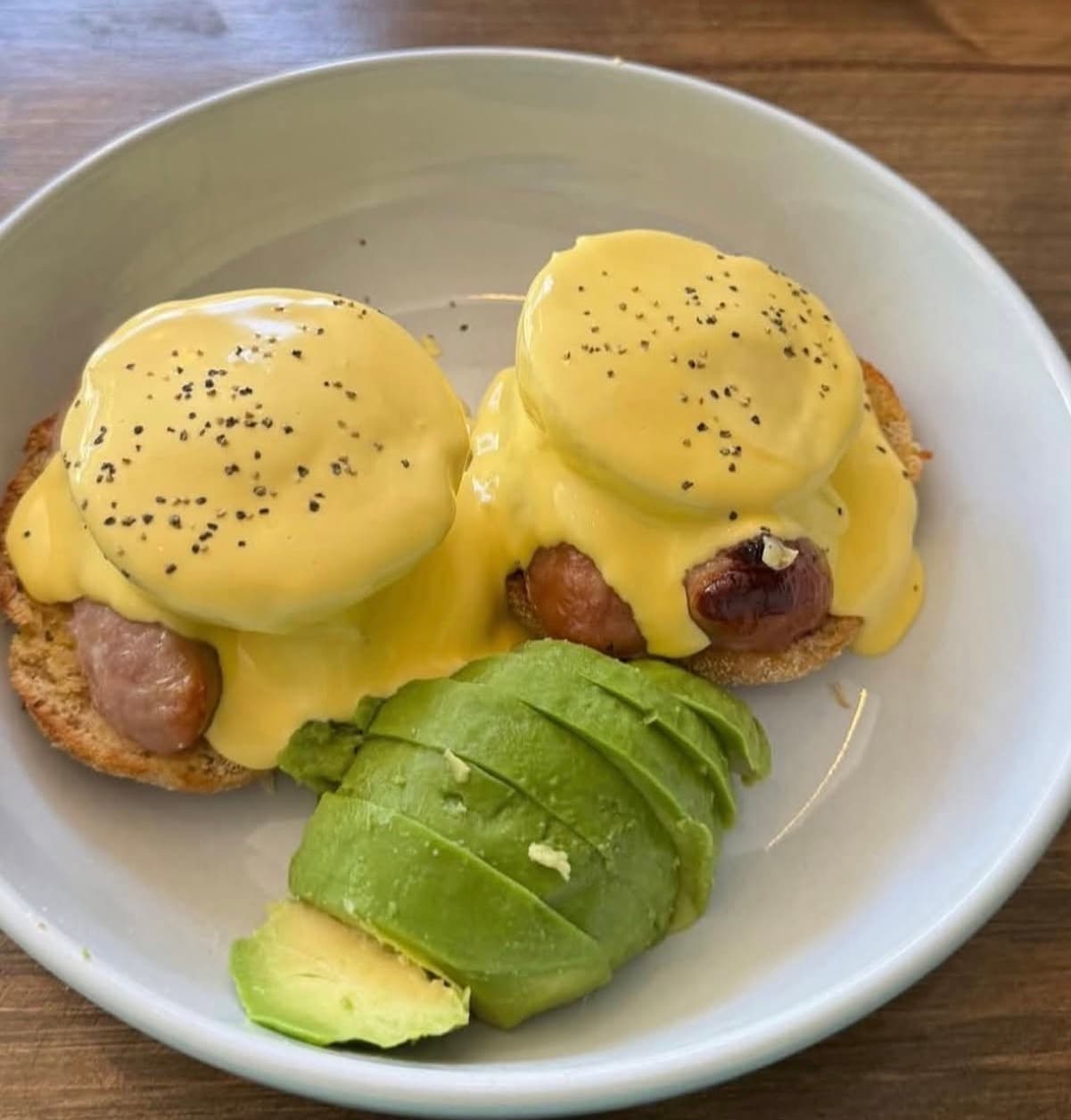 Eggs benedict with sliced avocado